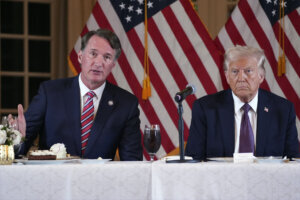 President elect Donald Trump listens as Virginia Gov. Glenn Youngkin speaks