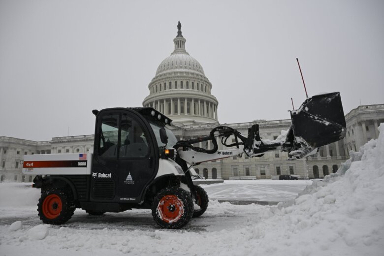 Front end loader clearing snow on Capitol Hill