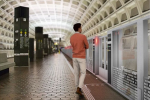 A man standing before track doors on a Metro train