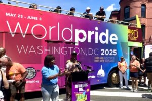 A rainbow clad, double decker bus