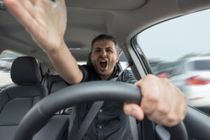 Young angry man driving his vehicle