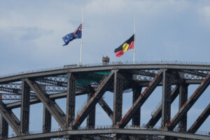 Australian and Aboriginal flags fly at half staff on the Sydney Harbour Bridge