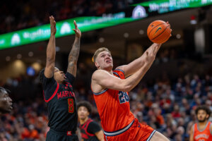 Virginia forward Thijs de Ridder drives by Maryland guard David Coit
