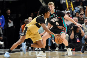 Washington Wizards guard Bub Carrington drives against Memphis Grizzlies guard Cam Spencer