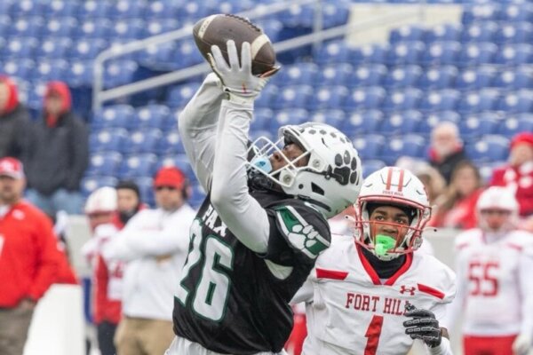 football player catching pass during game