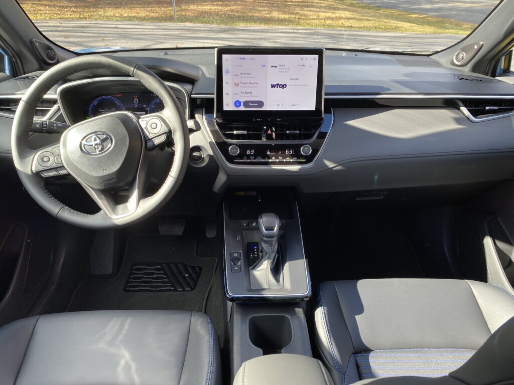 Inside of the front seat view with the steering wheel and touch screen for radio and navigation. (WTOP/John Aaron)