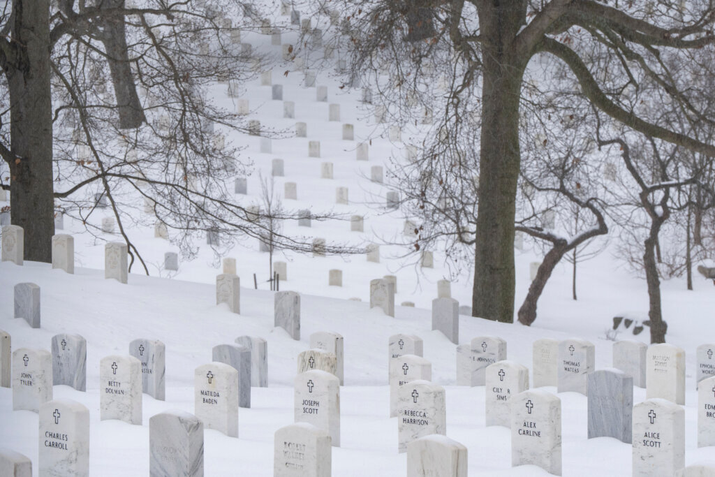 Snow blankets the headstones in Arlington National Cemetery, Sunday, Jan. 25, 2026, in Arlington, Va. (AP Photo/Alex Brandon)