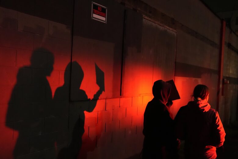 Protesters light by police light
