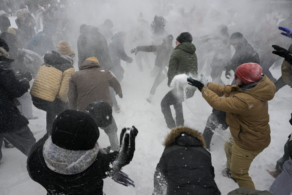 People participate in a snowball fight in Meridian Hill Park in Washington, DC, on January 25, 2026. A massive winter storm on January 24 dumped snow and freezing rain from New Mexico to North Carolina as it swept across the United States towards the northeast, threatening tens of millions of Americans with blackouts, transportation chaos and bone-chilling cold. After battering the country's southwest and central areas, the storm system began to hit the heavily populated mid-Atlantic and northeastern states as a frigid air mass settled in across the nation. (Photo by Oliver Contreras/AFP via Getty Images)