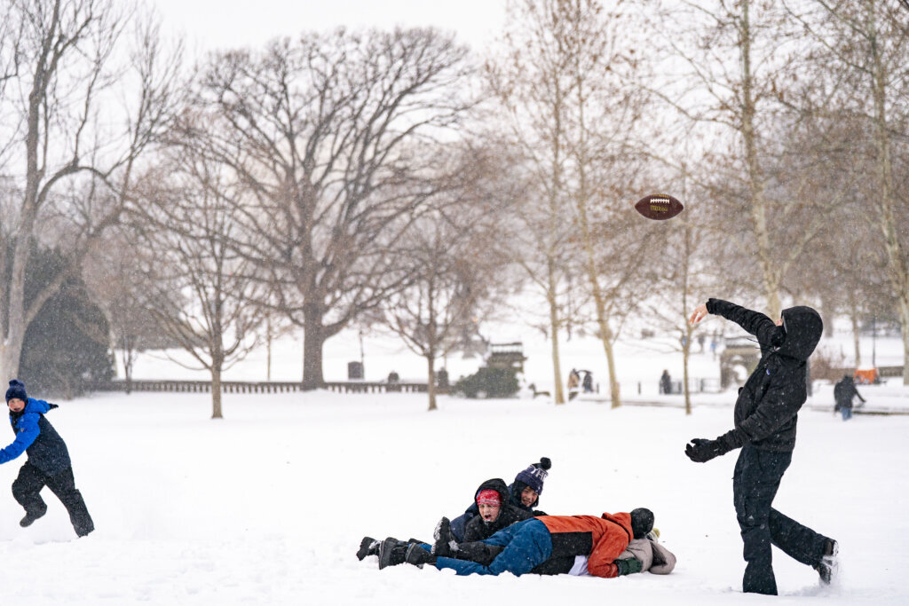 WASHINGTON, DC - JANUARY 25: Children play football on the West Front of the US Capitol on January 25, 2026 in Washington, DC. A massive winter storm is expected to bring frigid temperatures, ice, and snow to millions of Americans across the nation. (Photo by Al Drago/Getty Images)
