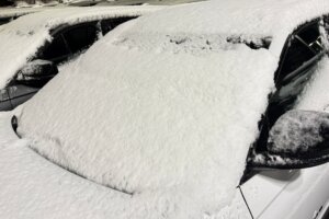 Snow on the windshield of car after snowstorm.