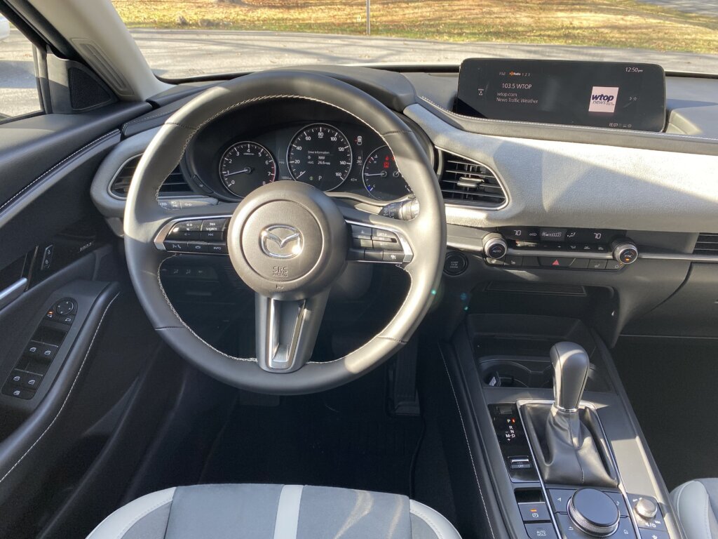 Inside, things are interesting too. Mazda uses white leatherette seats along with gray cloth inserts to striking effect. Just don't spill anything.