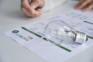 Close up view of a person checking electricity bill at home.