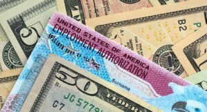 American,Us,Dollars,Money,Bills,With,Employment,Authorization,Card,Close