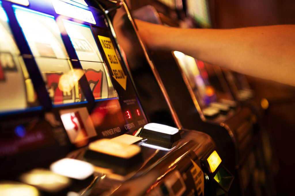 Player Engages With Slot Machine at Casino During Evening Entertainment