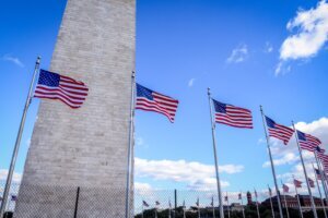 American flags in a row on a mast at the Washington monument in Washington DC