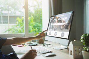 Job search concept, Businessman clicking internet job Search page on computer touch screen.