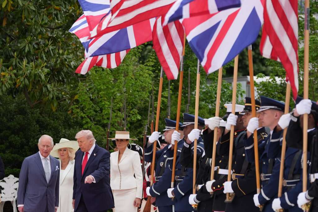President Donald Trump walks on the red carpet in the Rose Garden with Britain's King Charles III, Queen Camilla and first lady Melania Trump at White House, Tuesday, April 28, 2026, in Washington, during a State Visit. (AP Photo/Alex Brandon)