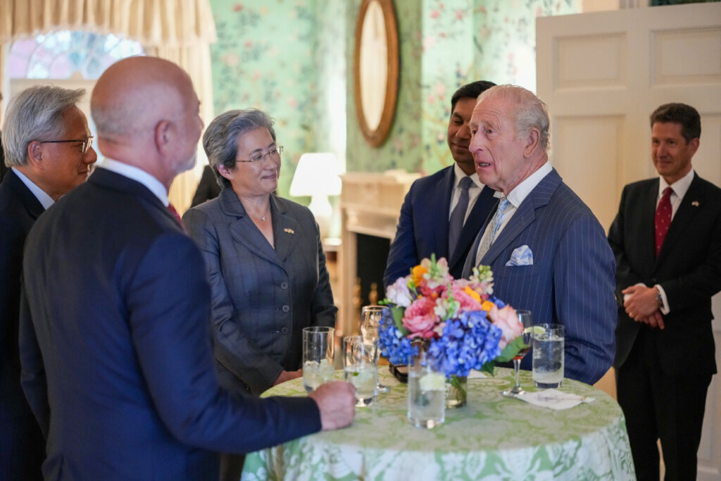 Britain's King Charles III speaks with Nvidia CEO Jensen Huang, Amazon founder Jeff Bezos and AMD President Lisa Su during a meeting of chief executives from the technology industry at Blair House, Tuesday, April 28, 2026, in Washington. (Ken Cedeno/Pool via AP)