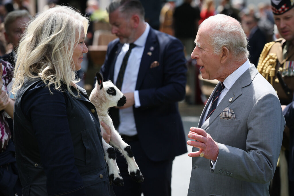 A Kerry Hill Welsh lamb named Upperville Charles, which was born last night, is shown to Britain's King Charles III by Tracey Bloom, owner of Kerry Hills of Upperville farm, during a parade and block party, Thursday, April 30, 2026, in Front Royal, Virginia. (Win McNamee/Pool Photo via AP)