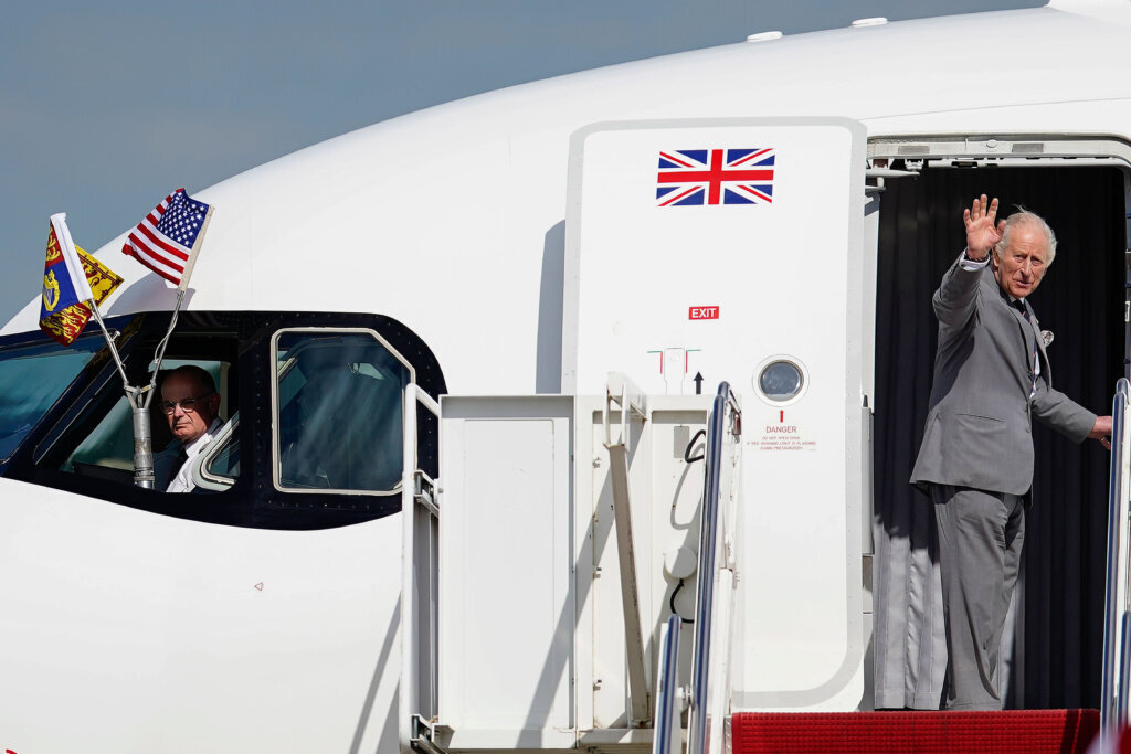 Britain's King Charles III waves as he boards his plane to depart at Joint Base Andrews, Maryland, Thursday, April 30, 2026. (AP Photo/Jose Luis Magana)