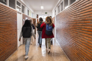 High school students walking down school hallway