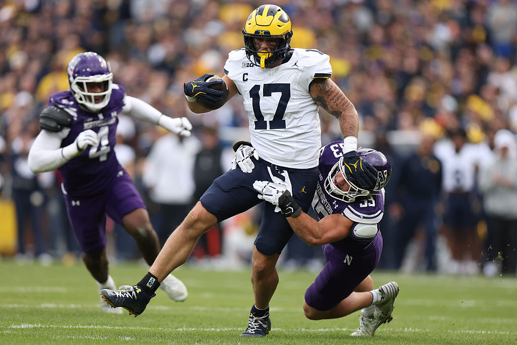 CHICAGO, ILLINOIS - NOVEMBER 15: Marlin Klein #17 of the Michigan Wolverines is tackled by Braydon Brus #33 of the Northwestern Wildcats during the first half at Wrigley Field on November 15, 2025 in Chicago, Illinois. (Photo by Michael Reaves/Getty Images)