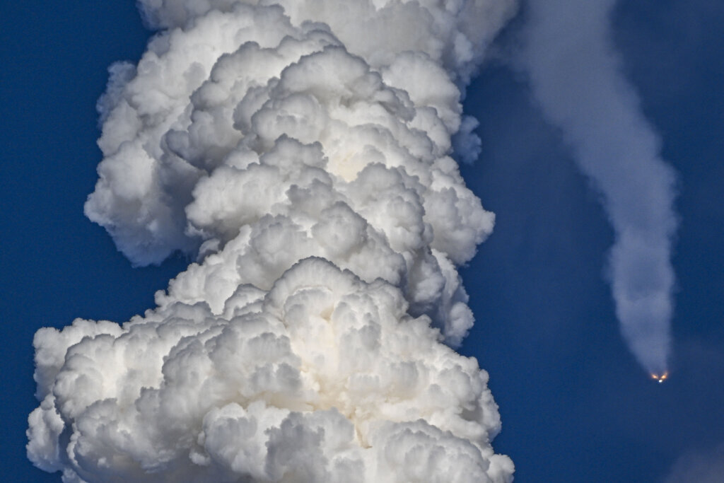Solid rocket boosters are seen as they fall away after separating from NASA's Space Launch System (SLS) rocket shortly after the Artemis II crewed lunar mission lift off from Pad 39B at Kennedy Space Center in Cape Canaveral, Florida, on April 1, 2026. (Photo by Miguel J Rodriguez Carrillo/AFP via Getty Images)