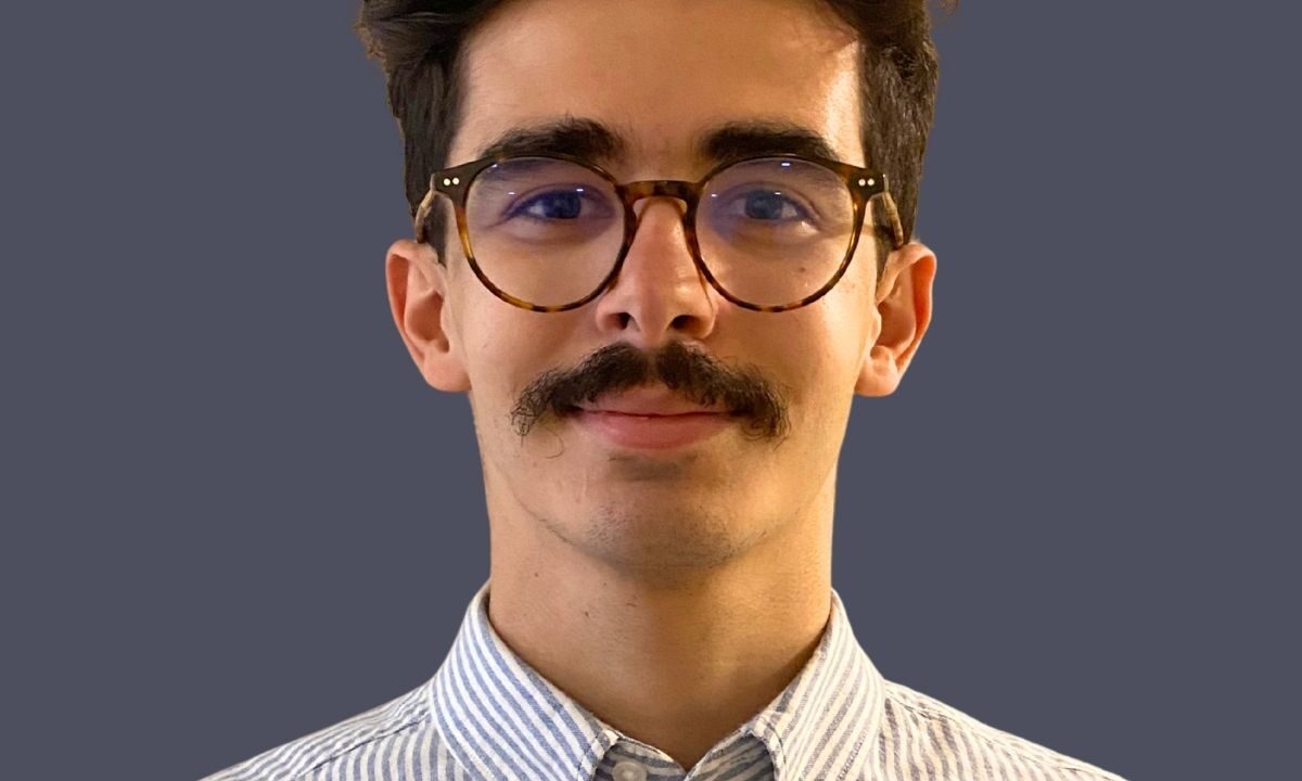 Man against dark background.