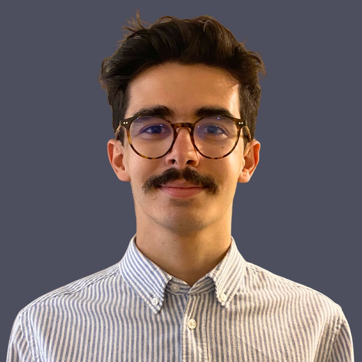 Man against dark background.