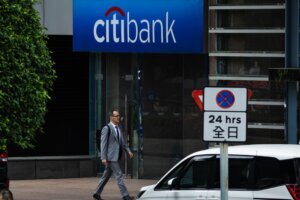 Man Walks Past Citibank Branch In Hong Kong