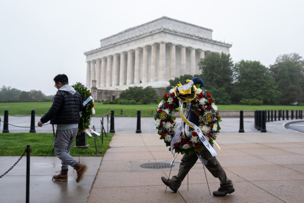 Individuals carry commemorative wreaths to place at the Vietnam Veterans Memorial on Memorial Day, Monday, May 25, 2026, in Washington. (AP Photo/Allison Robbert)