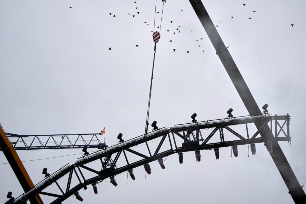 Cranes work on the UFC fighting ring on the South Lawn of the White House, Monday, May 25, 2026, in Washington. (AP Photo/Allison Robbert)