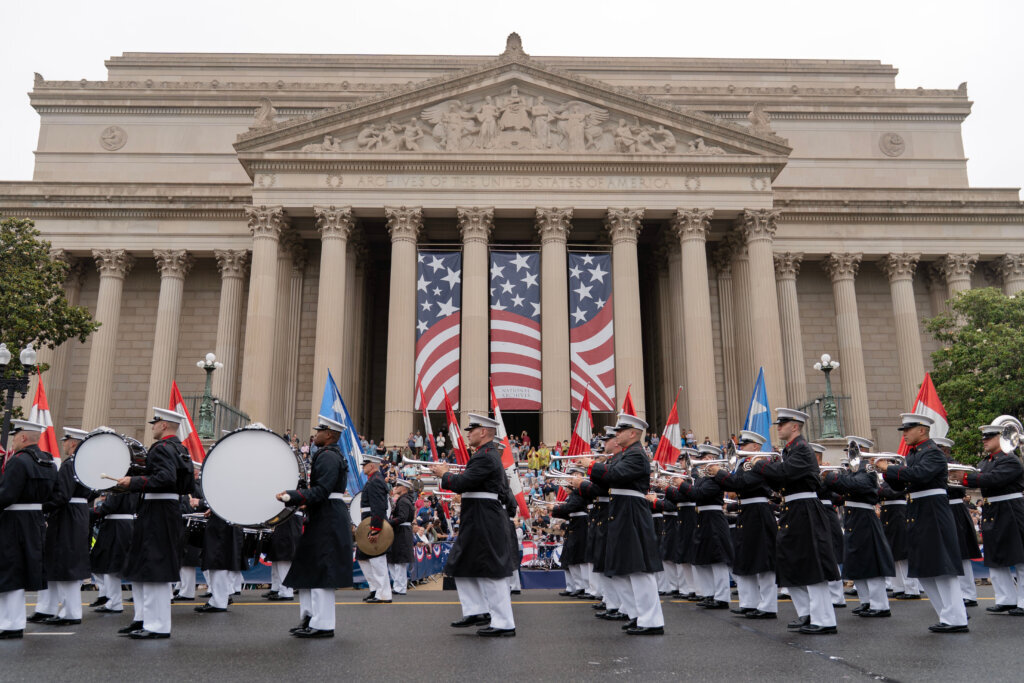 Parade participants march near the National Mall along Constitution Avenue in Washington to commemorate Memorial Day, Monday, May 25, 2026, coinciding with the nation's 250th anniversary celebrations. (AP Photo/Jose Luis Magana)