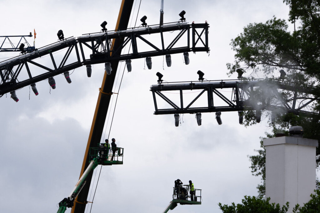 Crews work on the UFC fighting ring on the South Lawn of the White House, Monday, May 25, 2026, in Washington. (AP Photo/Allison Robbert)
