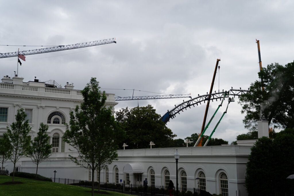 Crews work on the UFC fighting ring on the South Lawn of the White House, Monday, May 25, 2026, in Washington. (AP Photo/Allison Robbert)