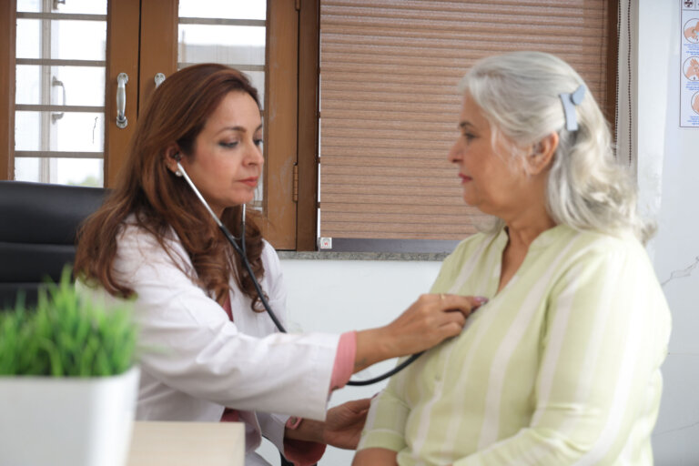 Doctor checking on elderly patient