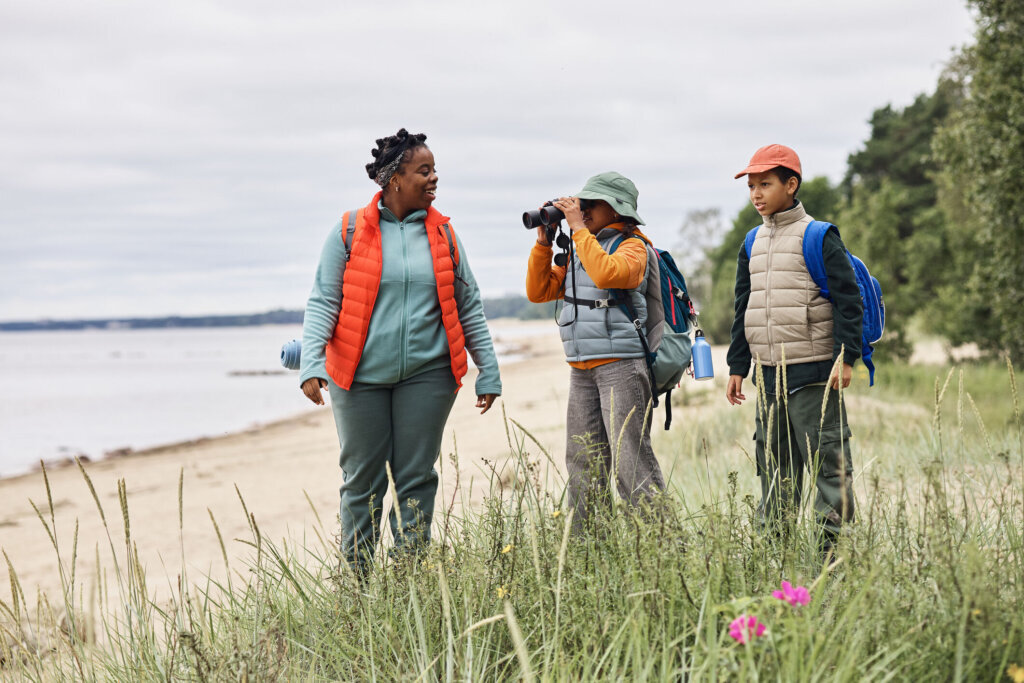 Family Hiking Along Beach Trail and Observing Nature Together