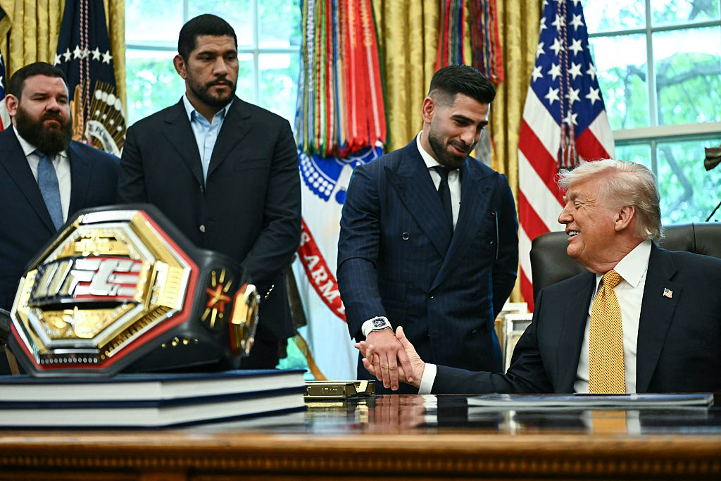 U.S. President Donald Trump (R) shakes hands with Georgian-Spanish mixed martial artist Ilia Topuria (2R) as he speaks about the upcoming "UFC Freedom 250" event, in the Oval Office of the White House on May 6, 2026, in D.C. (Photo by Kent NISHIMURA / AFP via Getty Images)