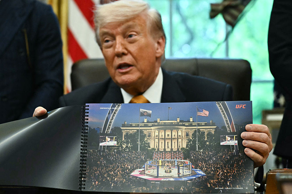 U.S. President Donald Trump shows a rendering of the upcoming "UFC Freedom 250" event as he speaks in the Oval Office of the White House on May 6, 2026, in D.C. (Photo by Kent NISHIMURA / AFP via Getty Images)