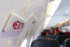 Close up shot sign in airplane near emergency exit doors