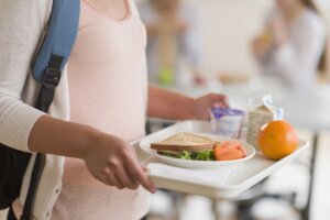 USA, New Jersey, Jersey City, Female student carrying tray in cafeteria