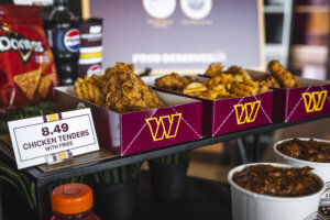 Cartons of wings and dipping containers of sauce sit at a Washington Commanders' press conference.